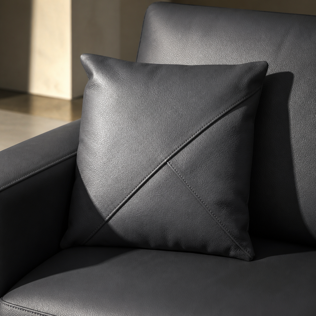 Close detail of the Surton leather scatter cushion with cross stitch panelling