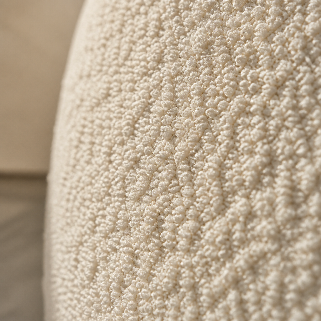 Close detail of the Formia cream boucle weave in raking daylight