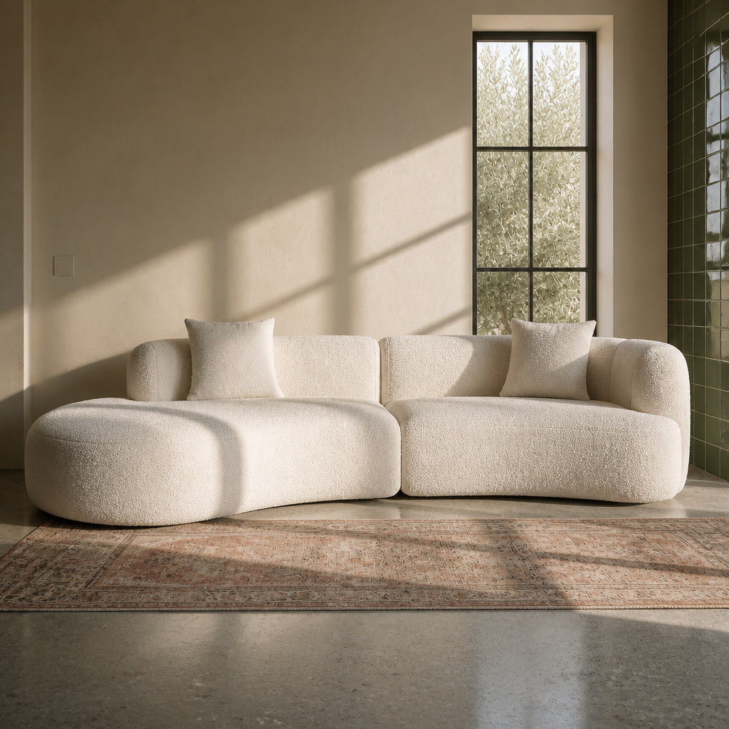 Front view of the Formia curved boucle sectional showing its full width and rounded chaise