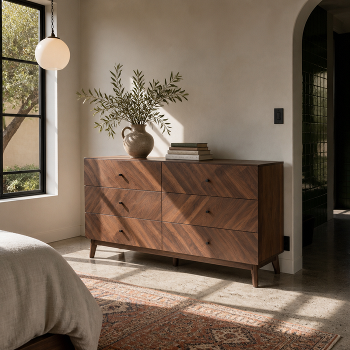 Hartman six drawer walnut dresser in a sunlit modern bedroom with concrete floors