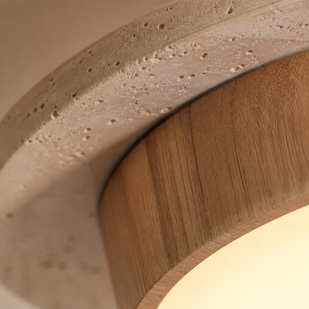 Macro detail of the pitted travertine stone meeting the walnut band on the Yellowstone light