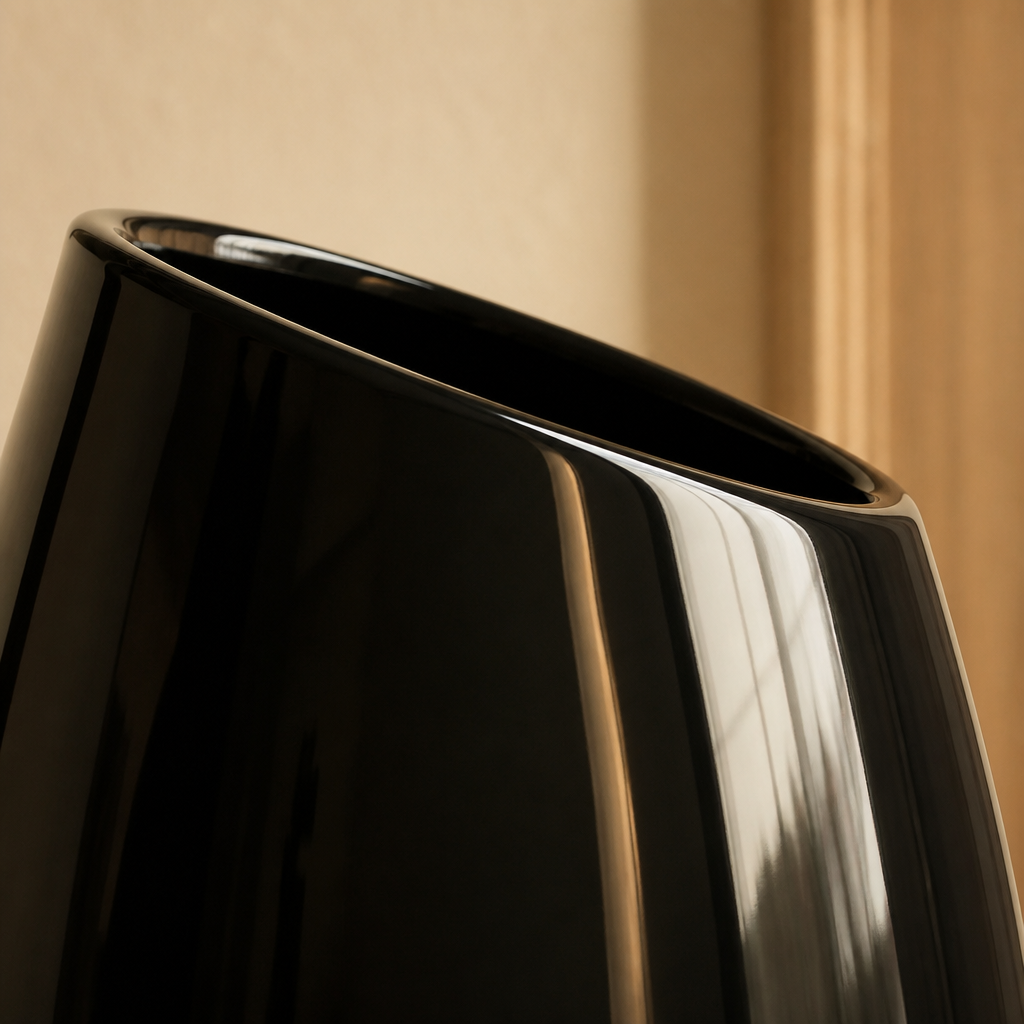 Close detail of the angled slanted rim on the tallest black ceramic vase