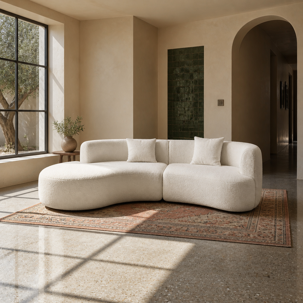 Formia curved cream boucle sectional sofa shown in full in a sunlit modern living room