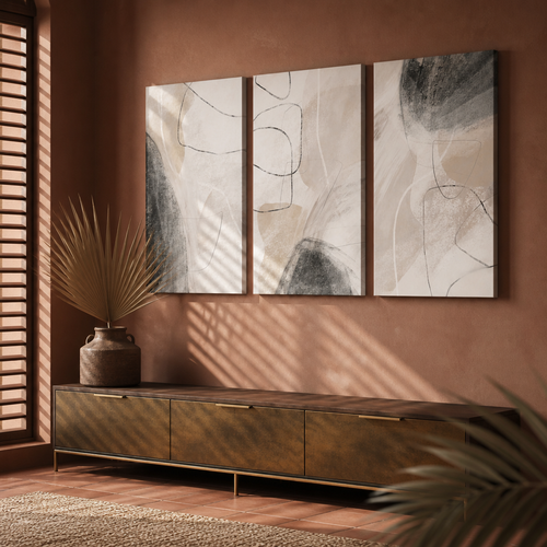 Three panel abstract boho canvas set hung above a low brass and timber console