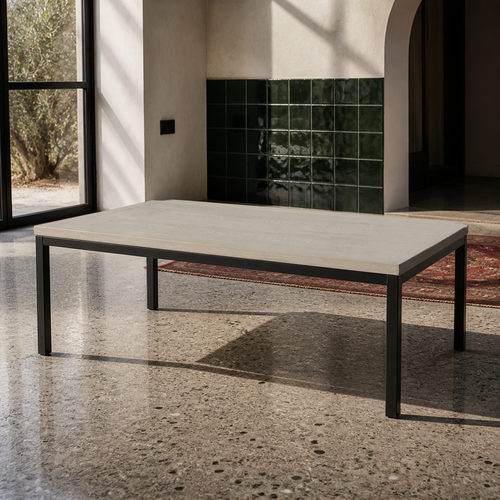 American coffee table with limed ash grey top and matte black steel frame on a polished concrete floor