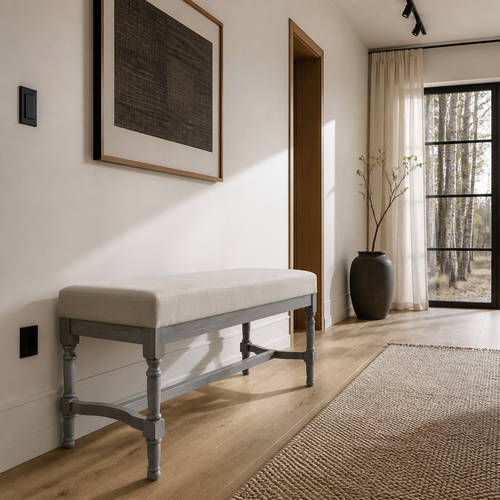 Grey-wash upholstered bench in a Nordic oak entry hall with black steel glazing