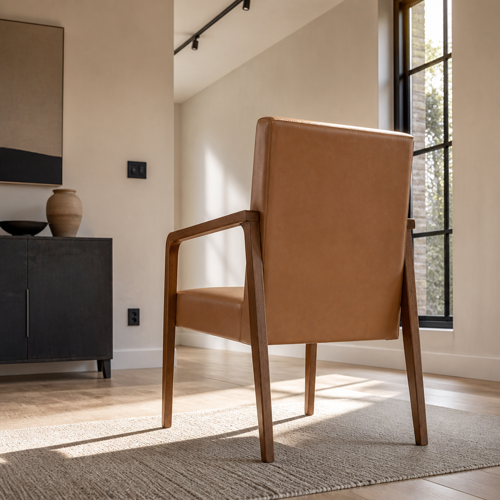 Rear three-quarter view of the Andrea accent chair showing the flat back panel and splayed rear legs
