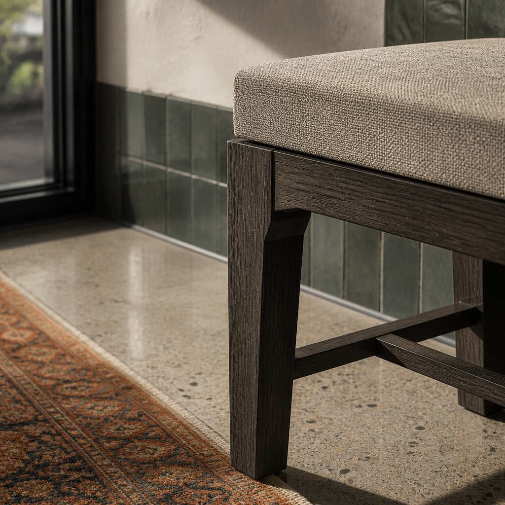 Oatmeal flecked seat fabric against espresso stained wood, material macro