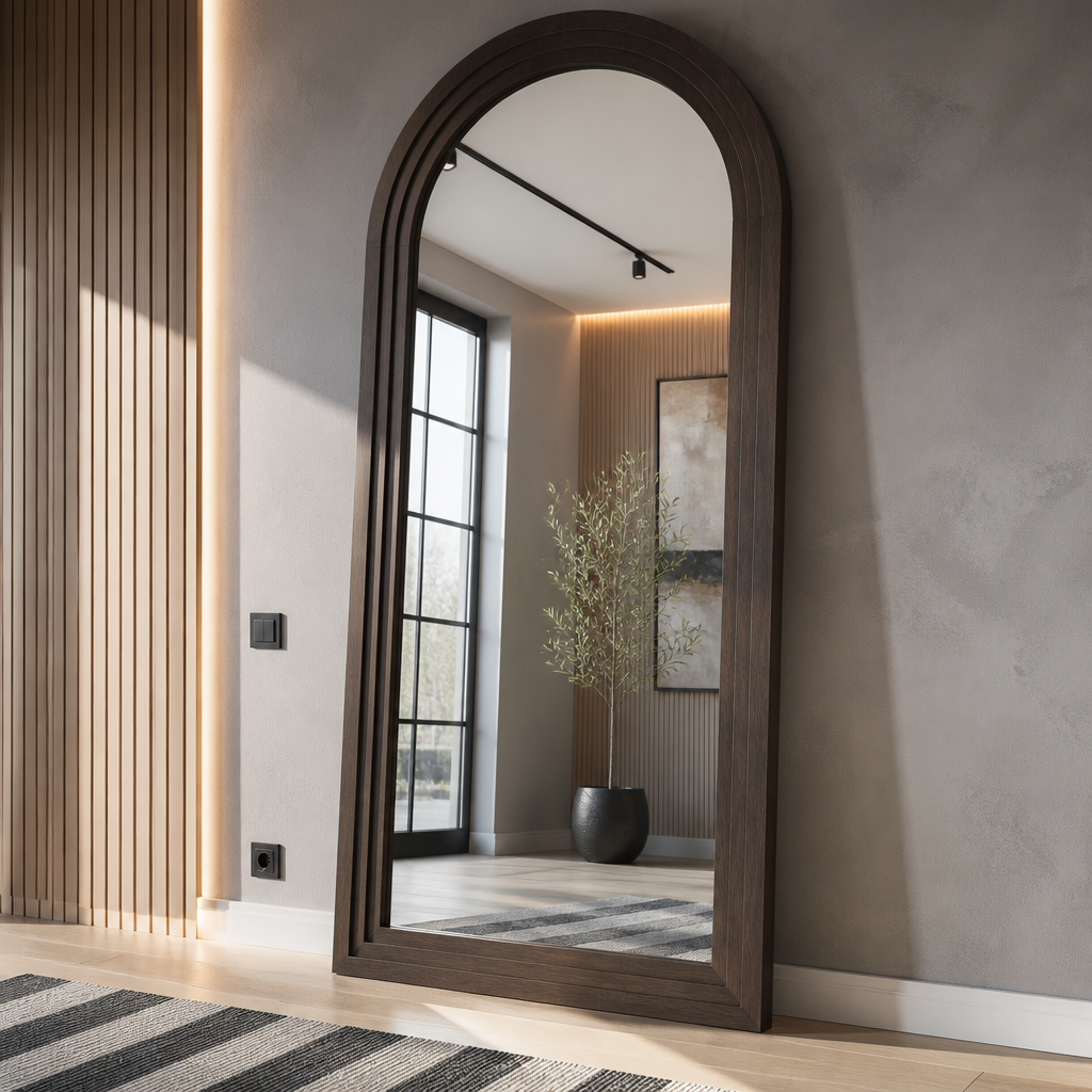 Three-quarter view of the arched farmhouse mirror showing the frame standing proud of the wall