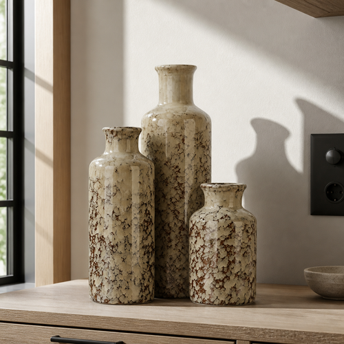 Set of three brown crackle-glaze ceramic farmhouse vases on a white oak console