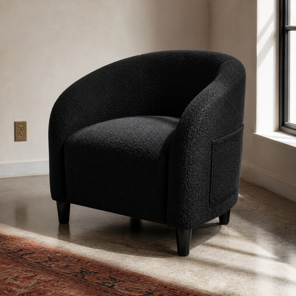 Black boucle barrel accent chair, close front three-quarter portrait in a bone plaster room