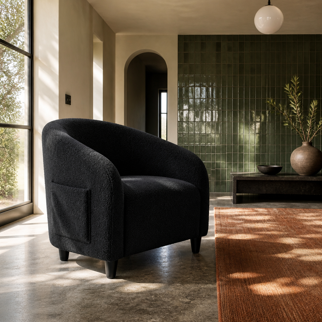 Black boucle barrel accent chair from the opposite side showing the outer arm and side pocket