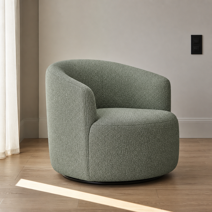 Sage green boucle swivel barrel chair, close front three-quarter portrait in a white plaster room