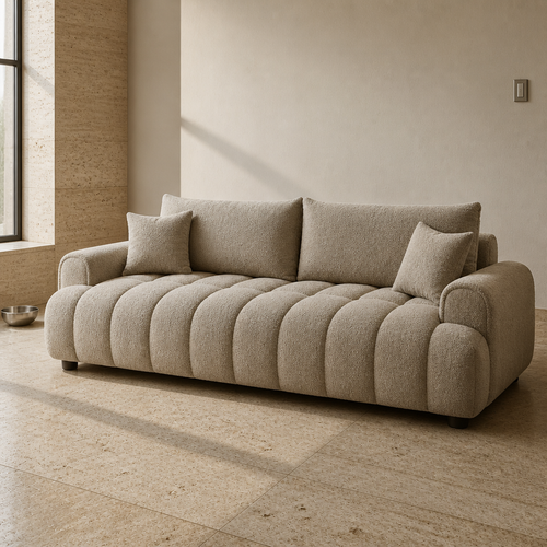 Camel boucle three-seat sofa, close front three-quarter portrait in a travertine gallery interior