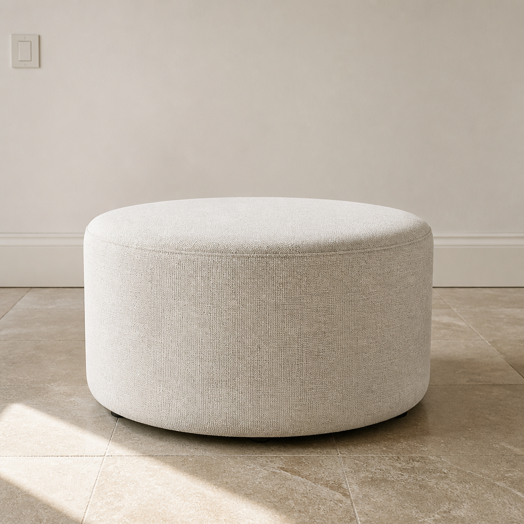 Callum round ivory heathered fabric ottoman, 29 inch diameter