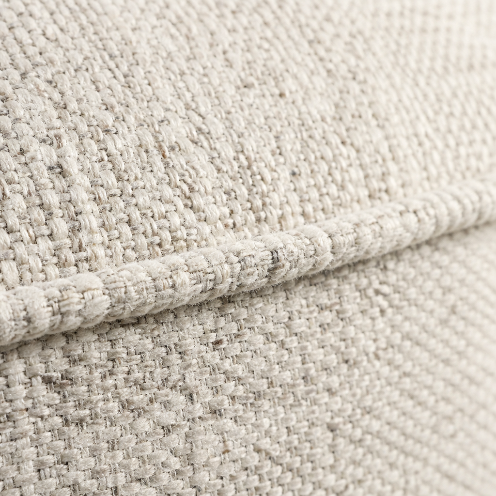 Macro of the Callum ottoman heathered ivory weave and welted top seam