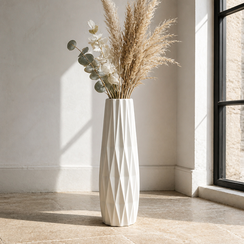 Tall faceted off white ceramic floor vase with dried pampas and eucalyptus