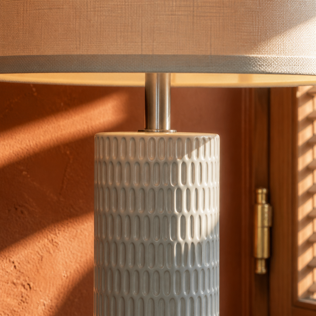 Close detail of the carved dash relief on the white ceramic column and brushed nickel stem