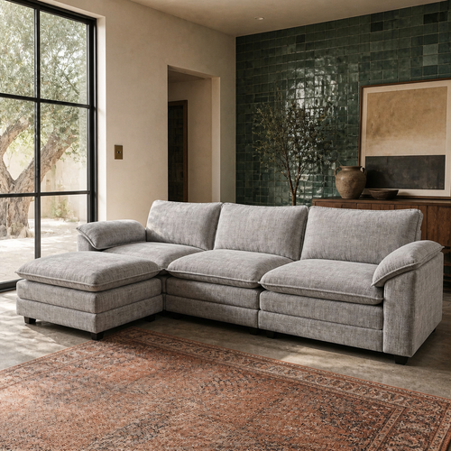 Grey chenille sectional sofa in a lime plaster room with green zellige tile accent