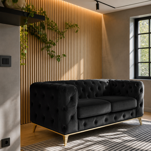 The black velvet Chesterfield loveseat against a backlit white oak slat wall on a light oak floor