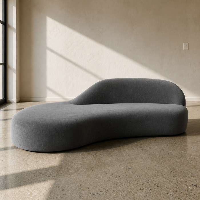 Cloud modern curved lounge couch in dark grey fleece, 90.9 inches long and 16.5 inches tall, resting directly on a polished concrete floor