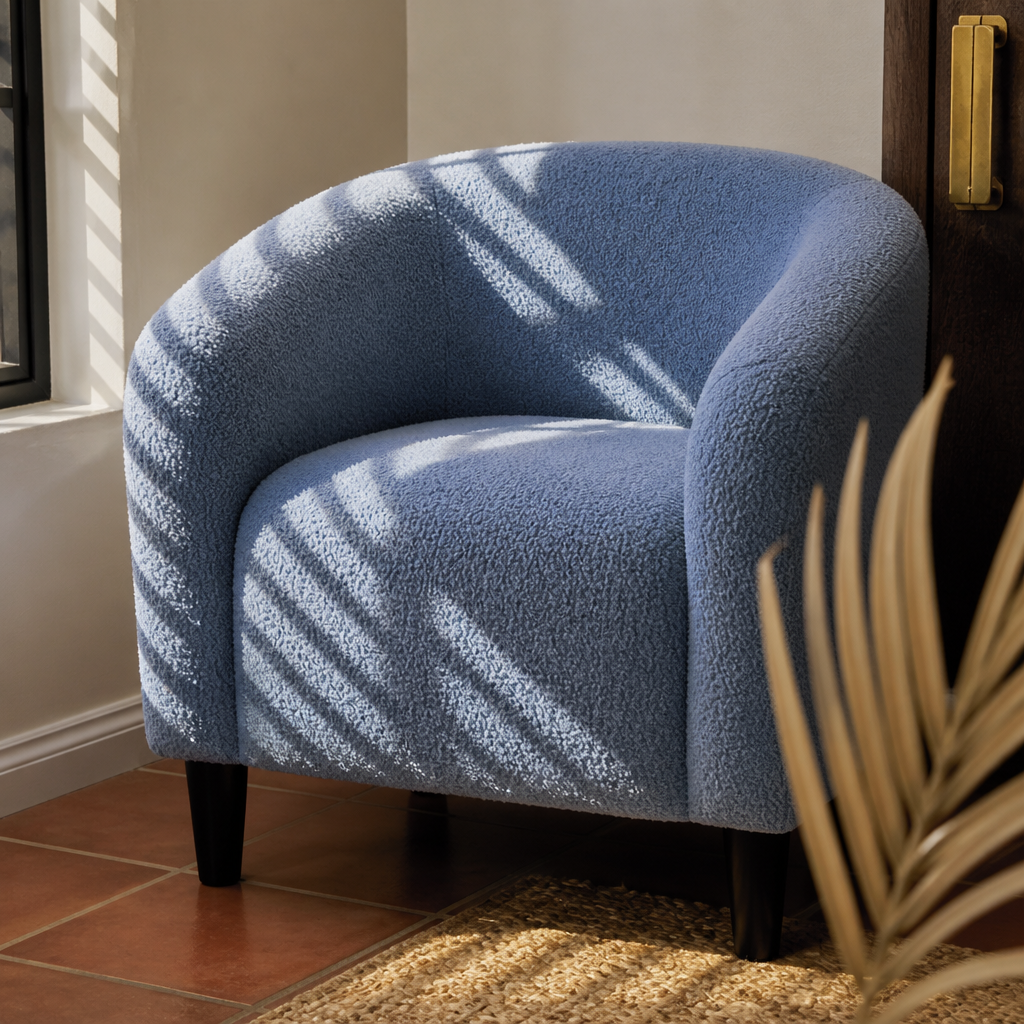 Close detail of the looped blue boucle on the arm roll and seat front of the accent chair
