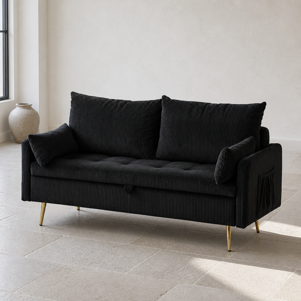 Black wide wale corduroy loveseat on gold legs, close product portrait in a lime wash room