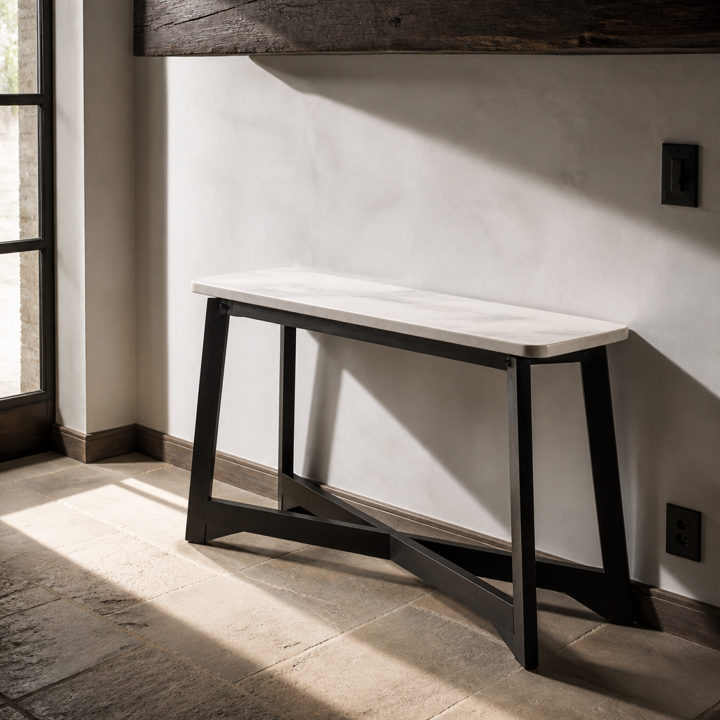 End view of the marble console table showing its narrow depth and X cross stretcher