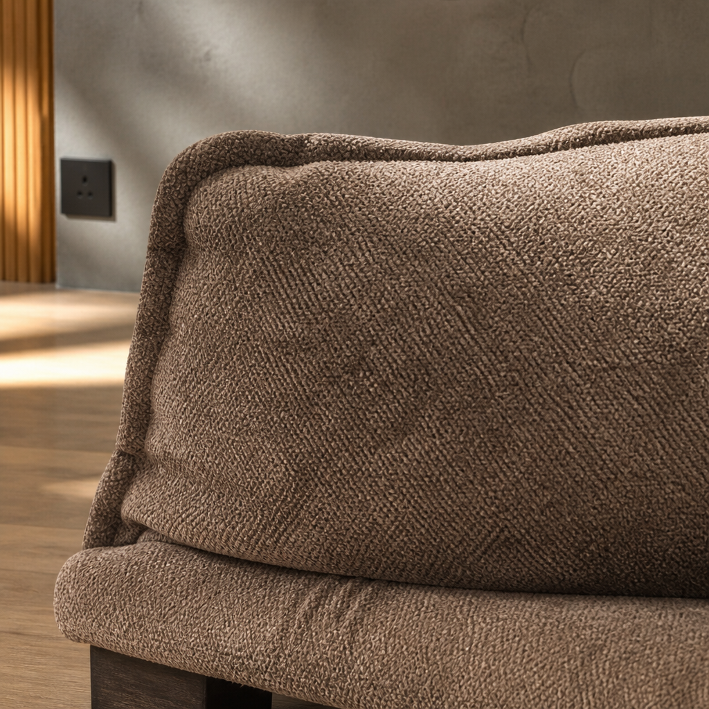 Macro detail of the warm brown chenille pile on a thick loose back cushion