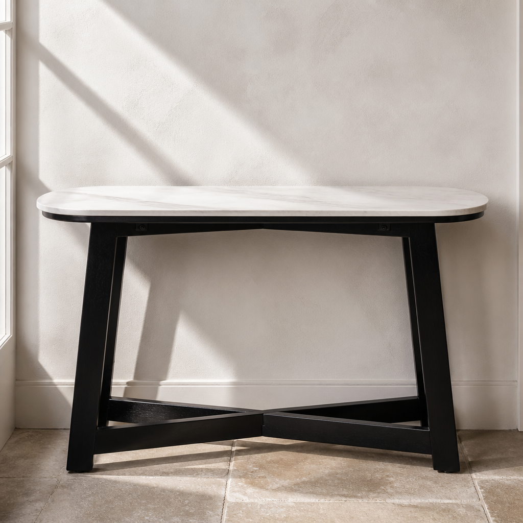 White marble console table with black splayed wood base, front view