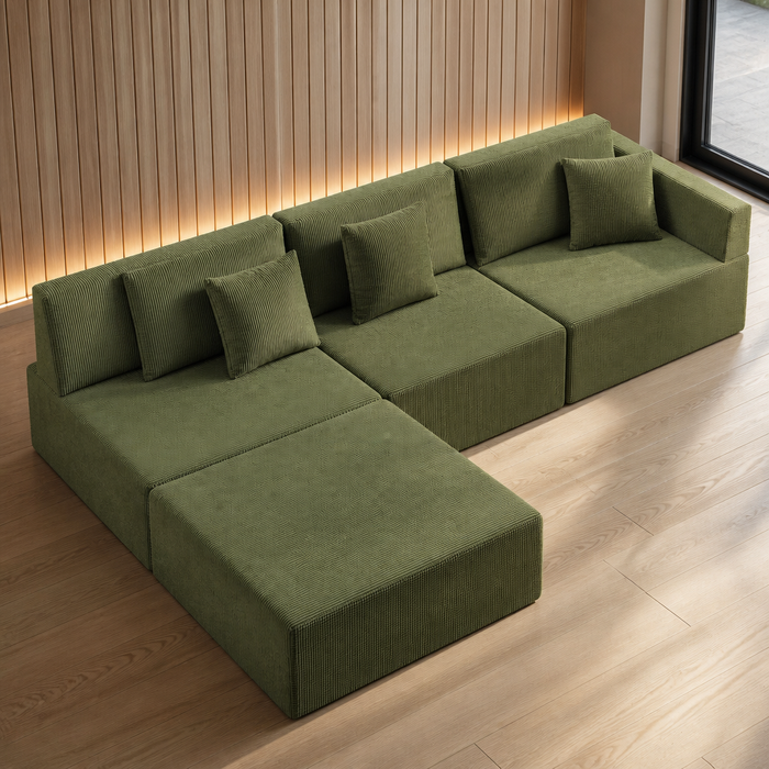 Olive green modular corduroy floor sectional with chaise block, armless foam modules sitting flush to the floor