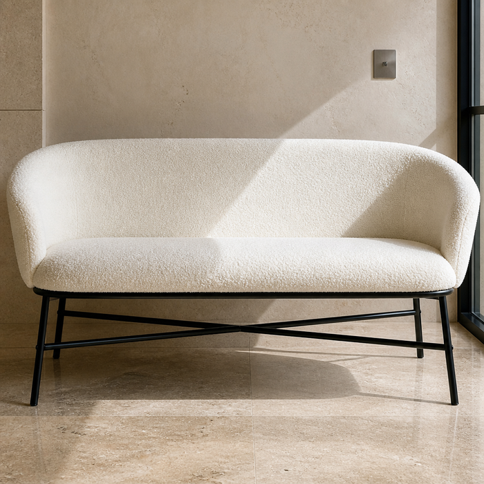 Ivory boucle settee on a black steel frame