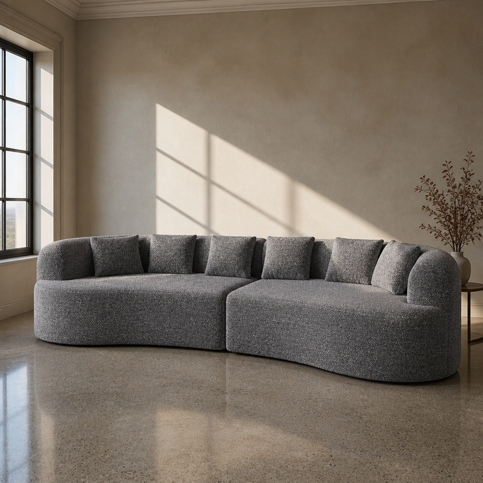 Curved Sectional Sofa in grey boucle, crescent plan with low rolled back and barrel arms