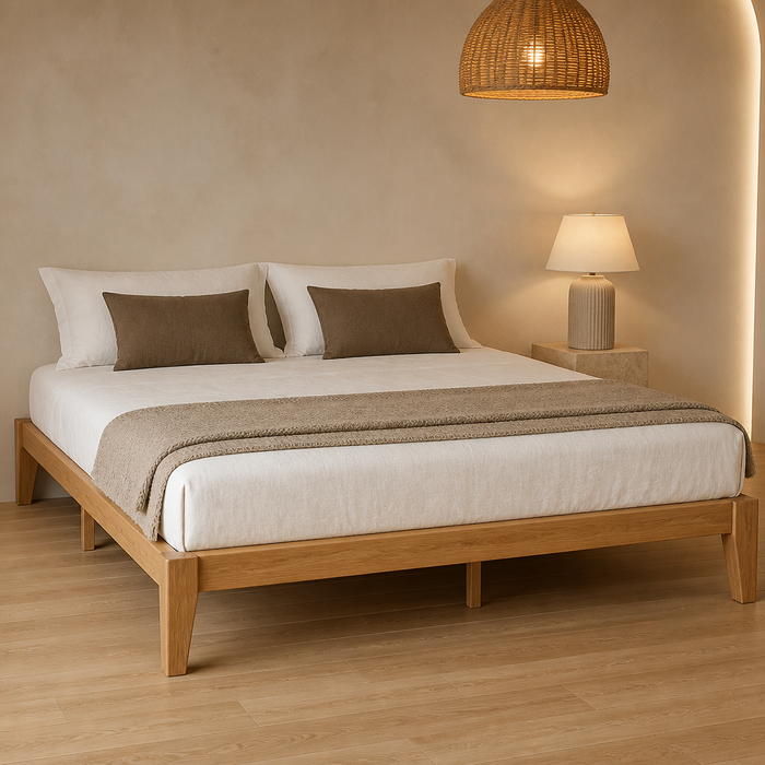 Light brown solid wood King platform bed frame with white linen bedding in a warm curved plaster bedroom