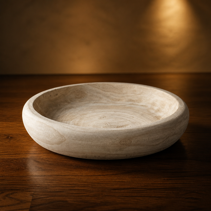 Farmhouse Natural Decorative Bowl, a shallow hand carved pale wood bowl with concentric grain, styled in a warm evening living room