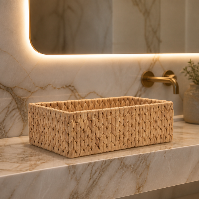 Hand-Woven Rattan Storage Basket - hero view on a marble vanity ledge